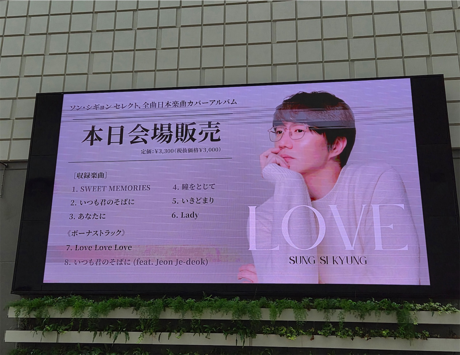 日本楽曲カバーアルバム『LOVE』の会場販売を告知する大型ビジョン